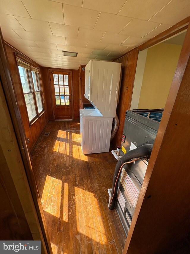 laundry room with hardwood / wood-style floors and wooden walls