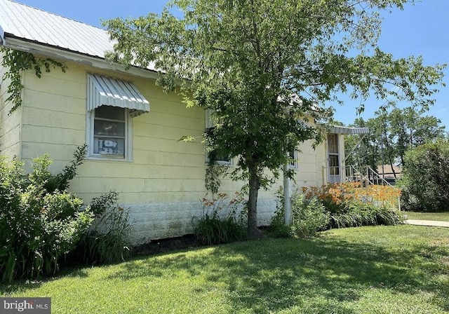 view of home's exterior with a lawn
