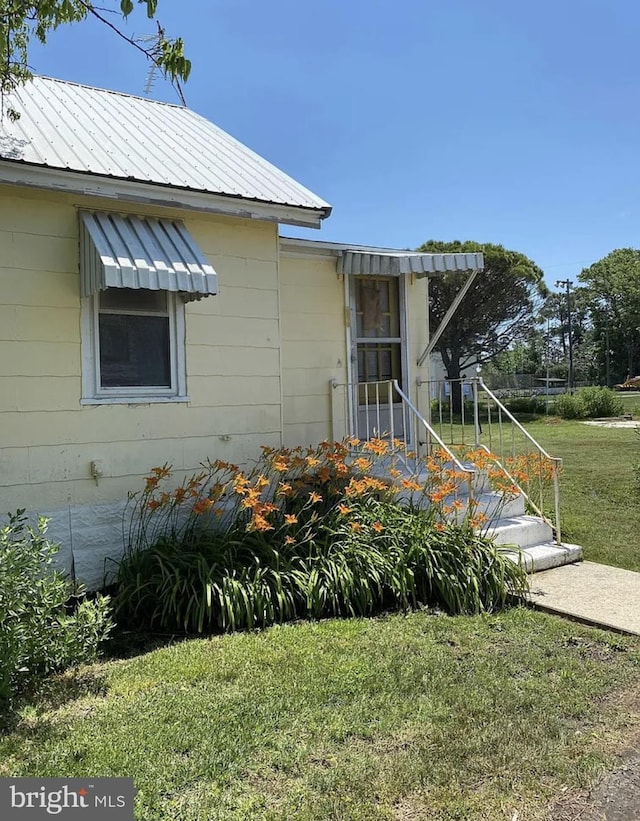 view of side of home featuring a lawn