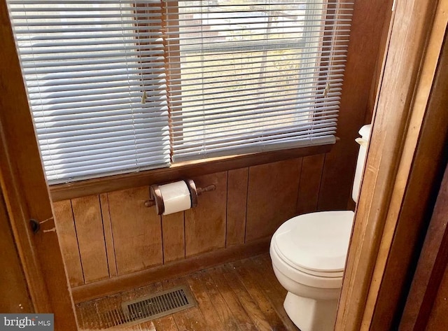 bathroom featuring hardwood / wood-style flooring and toilet