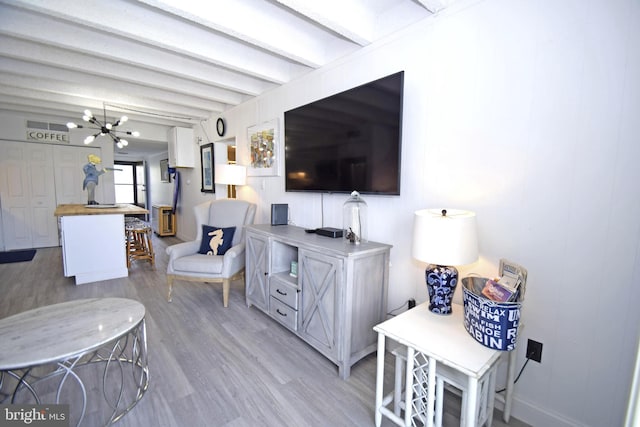 7604 Coastal Hwy Unit 2B, Ocean City, MD 21842 - living area with light wood-style floors, beam ceiling, a chandelier, and baseboards