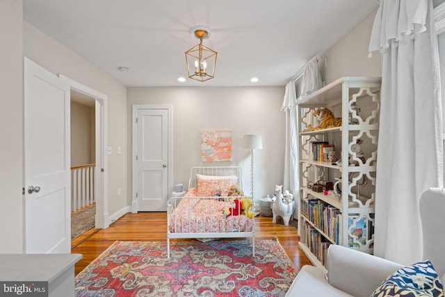 living area with light wood finished floors, a chandelier, and recessed lighting