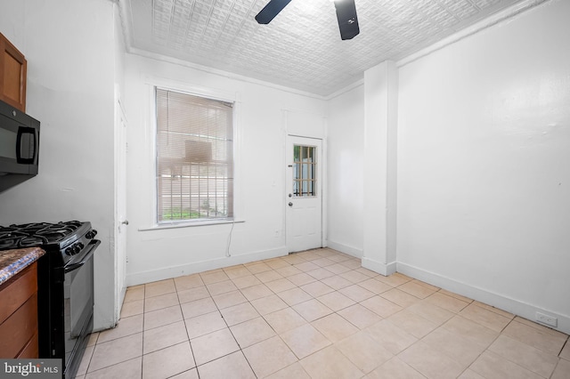 2717 Mosher St, Baltimore, MD 21216 - kitchen featuring black appliances, a ceiling fan, brown cabinets, light tile patterned floors, and an ornate ceiling