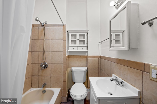 2717 Mosher St, Baltimore, MD 21216 - full bathroom featuring tile walls, shower / bathtub combination with curtain, vanity, toilet, and wainscoting