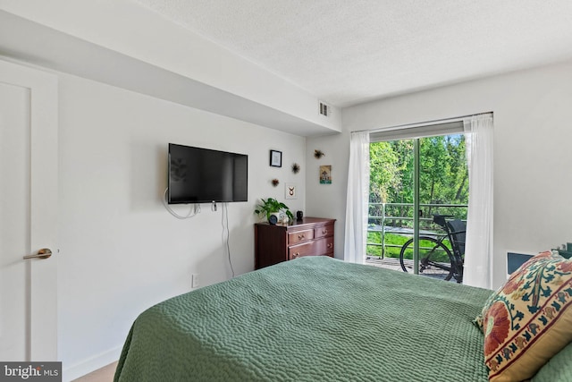 2141 Wisconsin Ave NW Unit 103, Washington, DC 20007 - bedroom with a textured ceiling, baseboards, and access to exterior