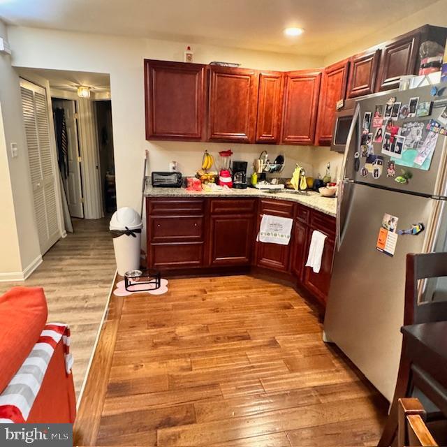 9330 China Grove Ct, Manassas, VA 20110 - kitchen with appliances with stainless steel finishes, light wood finished floors, recessed lighting, and reddish brown cabinets