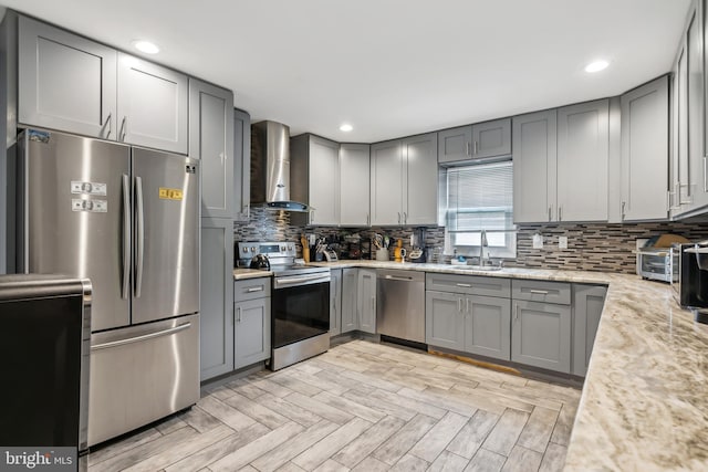 321 Taft St, Bristol, PA 19007 - kitchen with wall chimney exhaust hood, appliances with stainless steel finishes, gray cabinetry, a sink, and recessed lighting