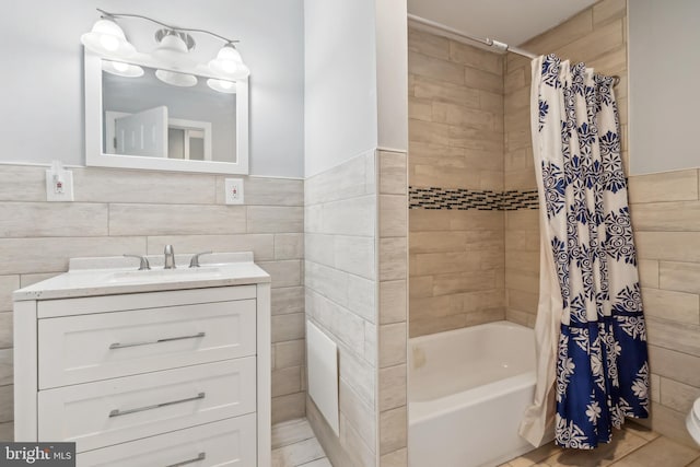 321 Taft St, Bristol, PA 19007 - full bath with shower / tub combo with curtain, vanity, tile walls, toilet, and a wainscoted wall