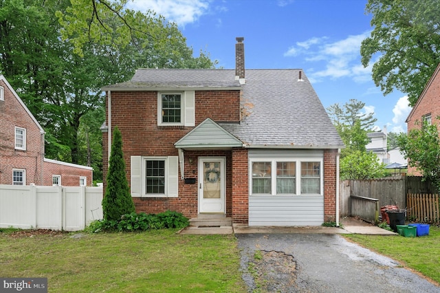 view of front of house with a chimney, brick siding, and entry steps