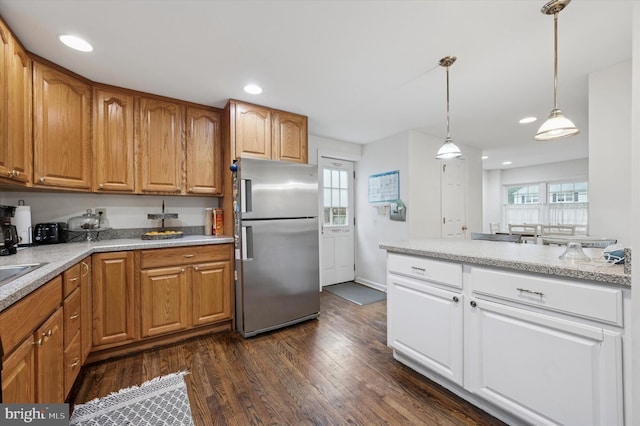 kitchen with freestanding refrigerator, recessed lighting, dark wood finished floors, pendant lighting, and white cabinets