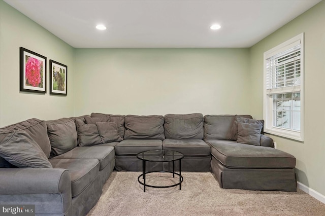 carpeted living area featuring recessed lighting and baseboards