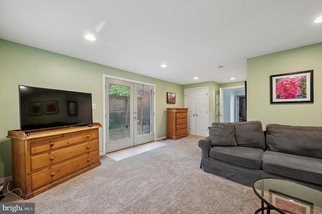 living room with french doors, light carpet, recessed lighting, and baseboards