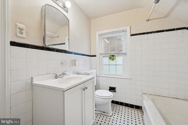full bath featuring tile walls, a tub to relax in, toilet, vanity, and a shower