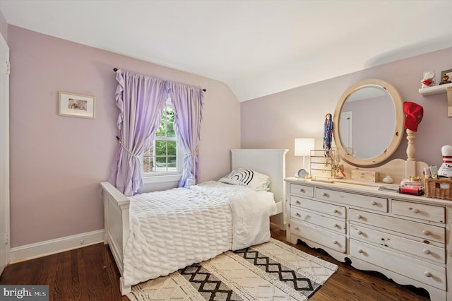bedroom with lofted ceiling, wood finished floors, and baseboards