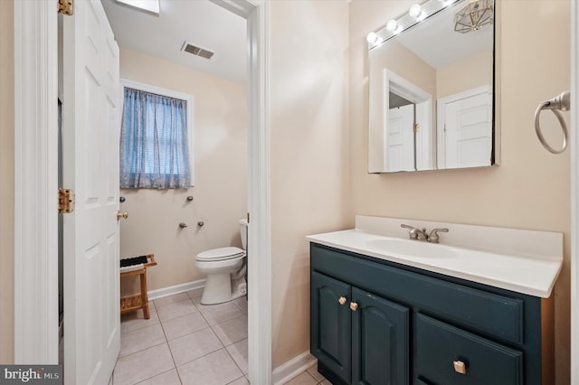 bathroom with vanity, tile patterned flooring, toilet, and baseboards