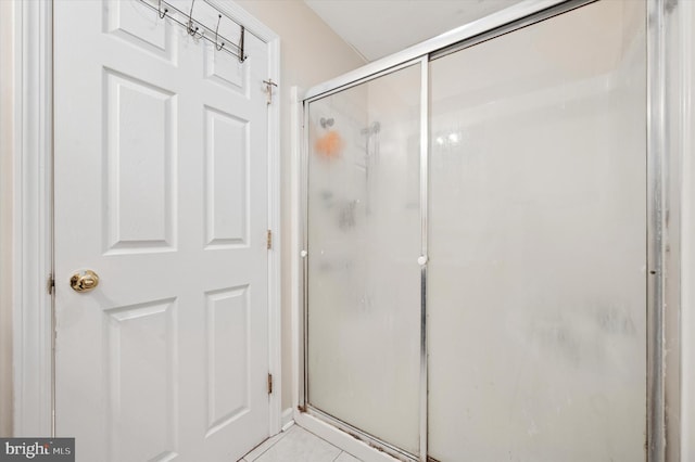 full bathroom with a shower stall and tile patterned flooring