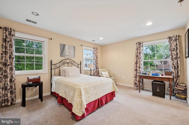 carpeted bedroom with multiple windows, baseboards, and recessed lighting