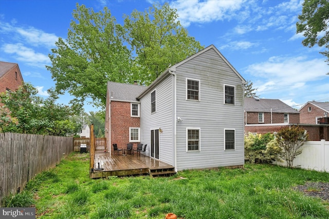 back of house featuring a wooden deck