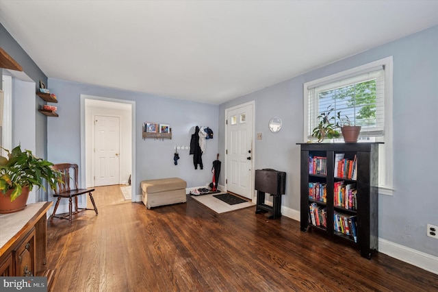 living area featuring wood finished floors and baseboards