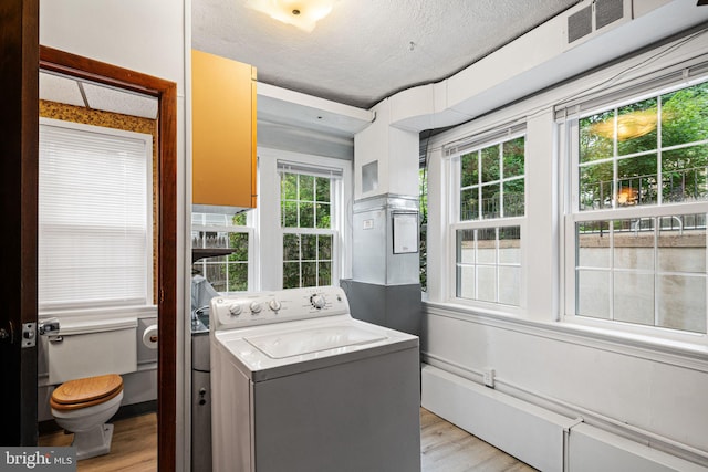 812 Pleasant Hill Rd, Wallingford, PA 19086 - laundry area featuring washer / dryer, light wood finished floors, and a textured ceiling