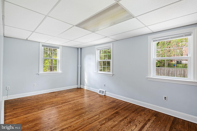 812 Pleasant Hill Rd, Wallingford, PA 19086 - unfurnished room with wood finished floors, baseboards, a paneled ceiling, and healthy amount of natural light