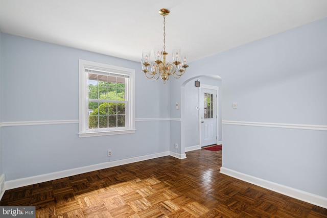 812 Pleasant Hill Rd, Wallingford, PA 19086 - empty room featuring arched walkways, baseboards, and a chandelier