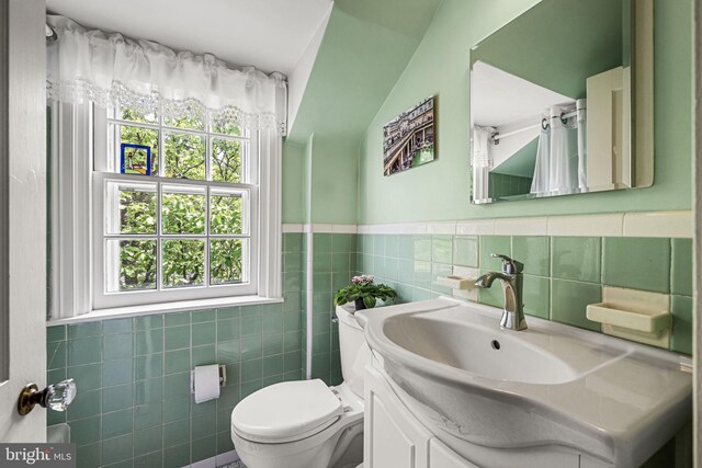 100 Chesney Ln, Erdenheim, PA 19038 - bathroom with tile walls, toilet, vanity, and wainscoting