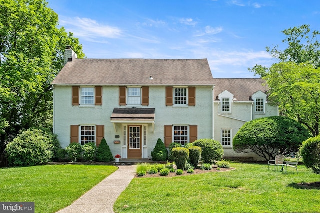 100 Chesney Ln, Erdenheim, PA 19038 - view of front of home featuring brick siding, a front yard, a chimney, and roof with shingles