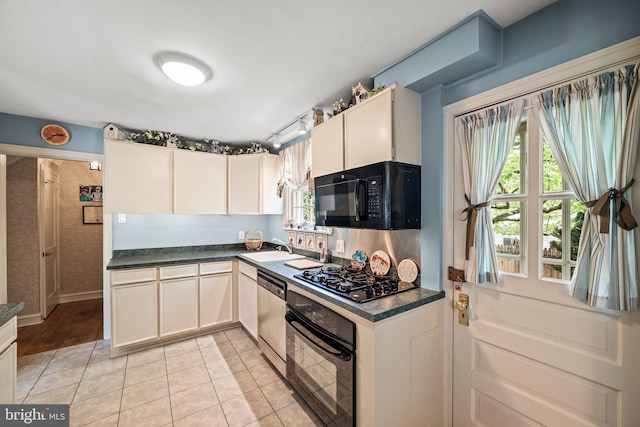 100 Chesney Ln, Erdenheim, PA 19038 - kitchen with black appliances, dark countertops, a sink, and light tile patterned flooring