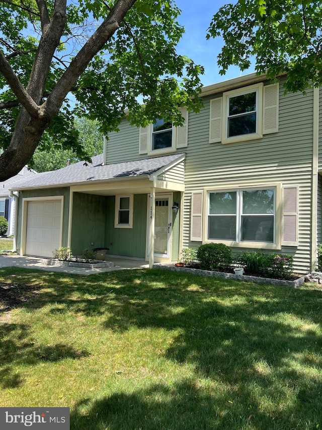 view of front facade with a front yard and an attached garage