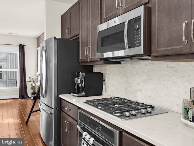 525 Leftwich Ln Unit 78, Annapolis, MD 21401 - kitchen featuring stainless steel appliances, dark brown cabinetry, light countertops, and hardwood / wood-style flooring