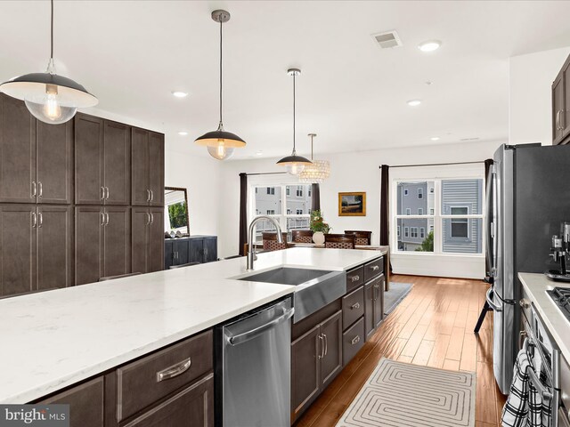 525 Leftwich Ln Unit 78, Annapolis, MD 21401 - kitchen featuring a sink, appliances with stainless steel finishes, wood finished floors, dark brown cabinetry, and pendant lighting