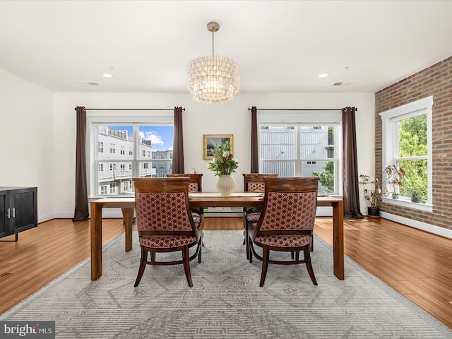 525 Leftwich Ln Unit 78, Annapolis, MD 21401 - dining room with light wood-style floors, a chandelier, baseboard heating, baseboards, and brick wall