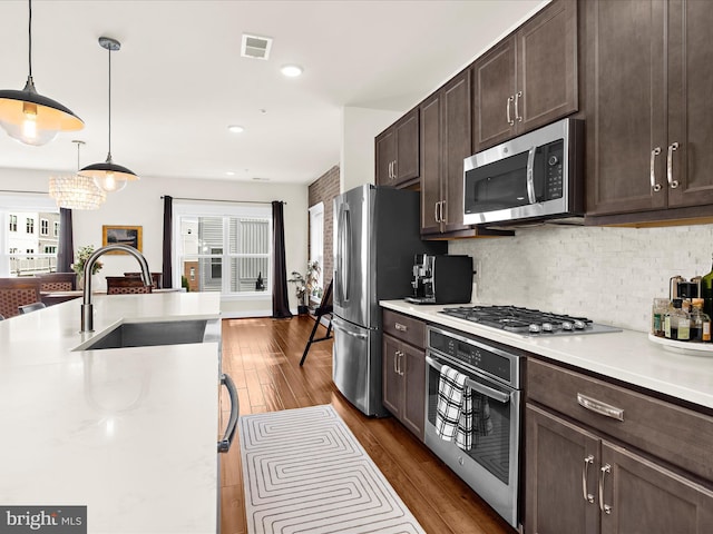 525 Leftwich Ln Unit 78, Annapolis, MD 21401 - kitchen with appliances with stainless steel finishes, a sink, dark brown cabinetry, light countertops, and decorative backsplash