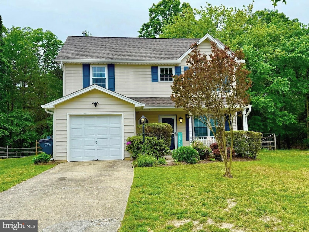 view of front of house with roof with shingles, a porch, and driveway
