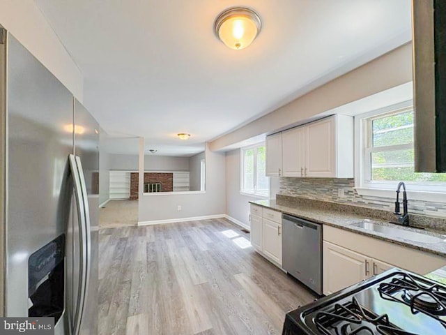 112 Hemlock Dr, Williamstown, NJ 08094 - kitchen featuring stainless steel appliances, a sink, light wood-type flooring, white cabinetry, and light stone counters