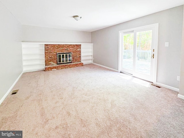112 Hemlock Dr, Williamstown, NJ 08094 - unfurnished living room featuring baseboards, carpet, a fireplace, and built in shelves