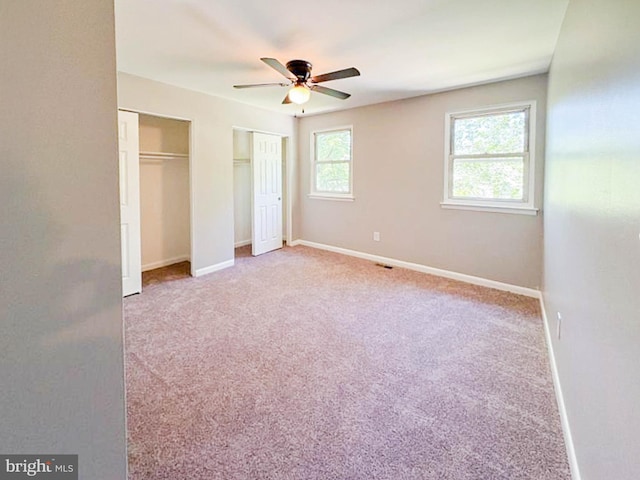 112 Hemlock Dr, Williamstown, NJ 08094 - unfurnished bedroom with two closets, carpet flooring, baseboards, and a ceiling fan