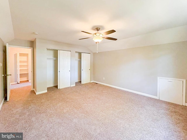 112 Hemlock Dr, Williamstown, NJ 08094 - unfurnished bedroom featuring multiple closets, light carpet, baseboards, and vaulted ceiling