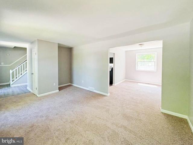 112 Hemlock Dr, Williamstown, NJ 08094 - empty room with carpet floors, baseboards, and stairway