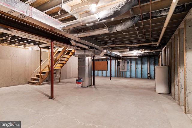 unfinished below grade area featuring electric panel, water heater, heating unit, and stairs