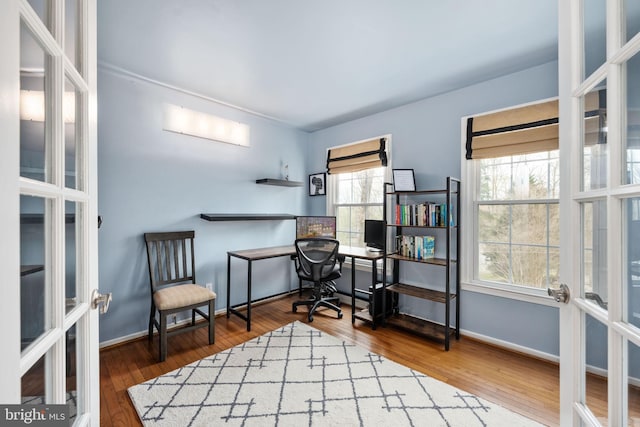 office area featuring wood finished floors, baseboards, and french doors