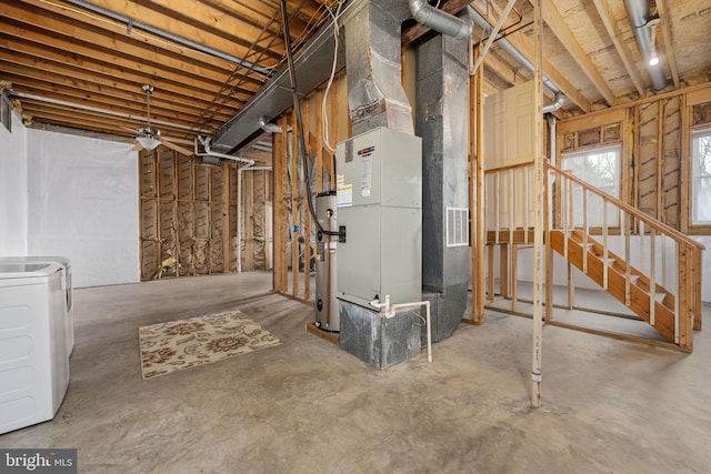 basement with heat pump water heater, stairs, and washer / clothes dryer