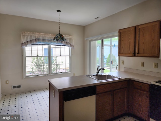 16 Lantern Ln, Columbus, NJ 08022 - kitchen featuring dishwasher, a sink, a peninsula, brown cabinets, and light floors