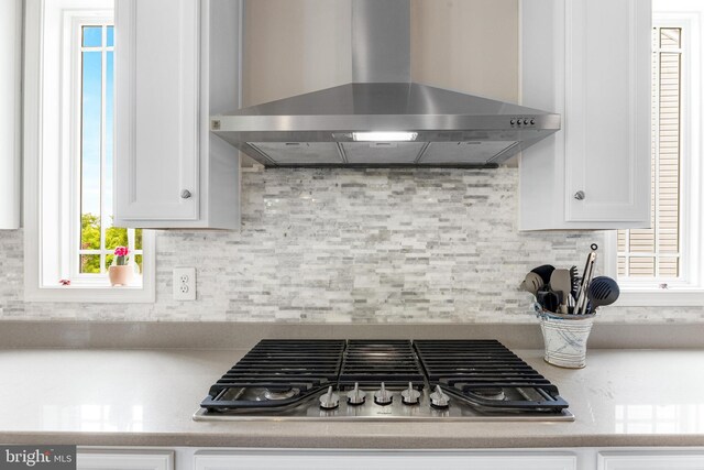 5519 Golden Eagle Rd, Frederick, MD 21704 - kitchen with wall chimney range hood, stainless steel gas stovetop, white cabinetry, and backsplash