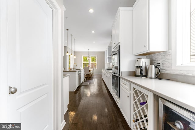 5519 Golden Eagle Rd, Frederick, MD 21704 - kitchen with wine cooler, dark wood-type flooring, white cabinetry, light countertops, and tasteful backsplash