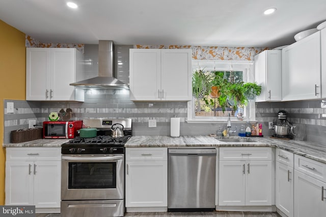 449 7th Ave, Lindenwold, NJ 08021 - kitchen with stainless steel appliances, wall chimney range hood, a sink, white cabinetry, and recessed lighting