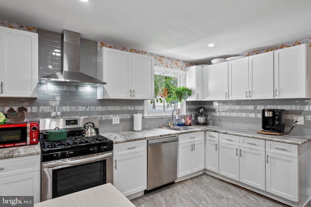 449 7th Ave, Lindenwold, NJ 08021 - kitchen with wall chimney range hood, appliances with stainless steel finishes, white cabinets, backsplash, and recessed lighting