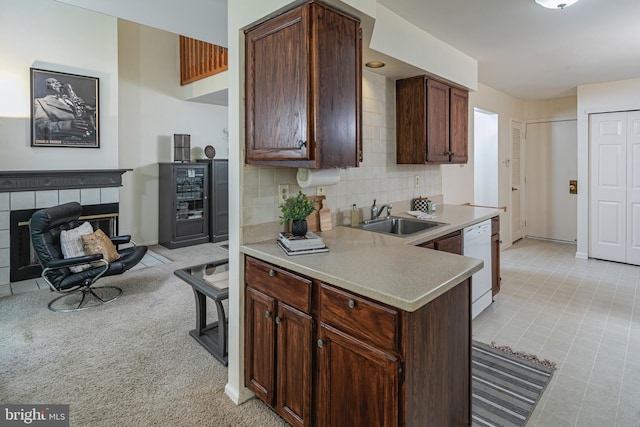 36F Needham Way, Princeton, NJ 08540 - kitchen featuring white dishwasher, light countertops, a fireplace, tasteful backsplash, and light carpet