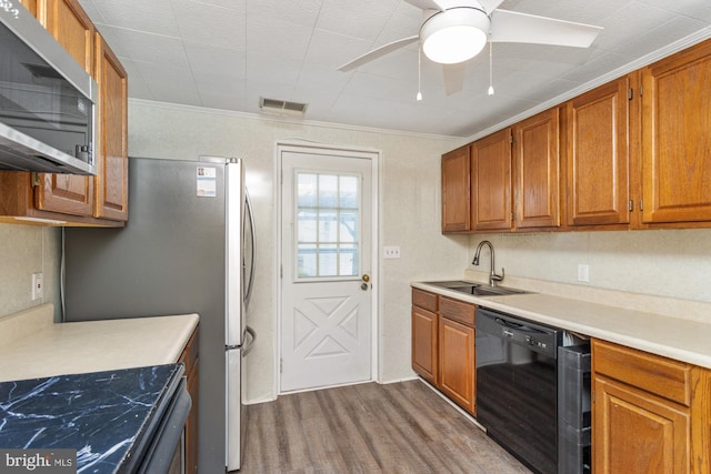 3135 Sollers Point Rd, Baltimore, MD 21222 - kitchen with black appliances, a sink, wood finished floors, a ceiling fan, and brown cabinets